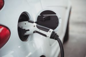 close up of car being charged with electric car charger